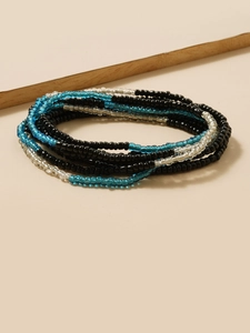 Macro view of multi-layered beaded waist chain with blue and black glass seed beads