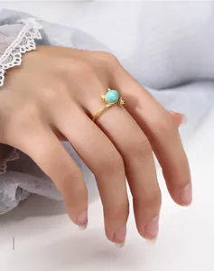 Detail of a cat-shaped 925 sterling silver ring with blue stone on a hand