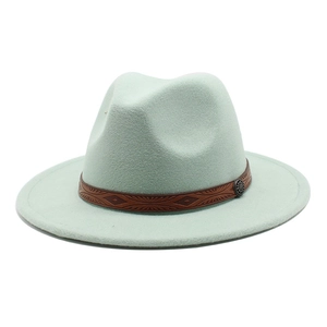 Detail of mint green fedora wool hat with brown embossed faux leather band and metal buckle