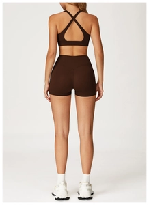Rear view of brown yoga set featuring a cross-back sports bra and high-waist shorts
