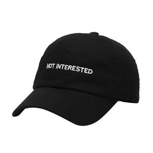 Black cotton baseball cap with white NOT INTERESTED embroidery and curved brim