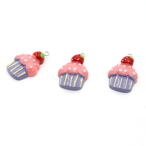 Close-up of resin strawberry cupcake pendants with purple base for DIY jewelry making