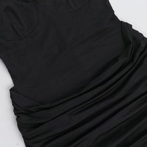 Detail of black pleated fabric showing textured ruched design and fine stitching