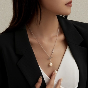 Detailed view of baroque freshwater pearl necklace with T-bar clasp on model