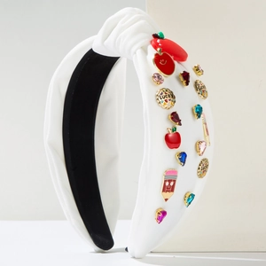 White knotted fabric headband featuring red apple charms and colorful gemstone accents
