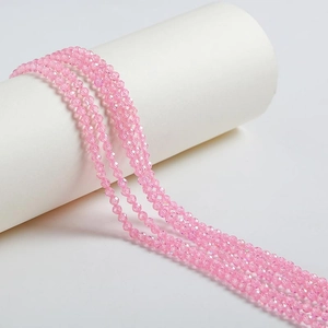 Pink faceted zircon crystal beads strand wrapped around a white column for DIY jewelry