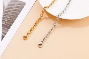Close-up of gold and silver stainless steel chain bracelets with lobster clasps