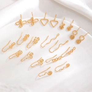 Minimalist handmade gold wire nose cuffs set with geometric spiral and heart designs
