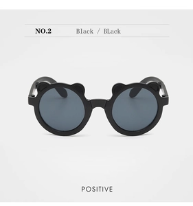 Front view of black foldable kids' sunglasses with cute bear ear frames and dark lenses
