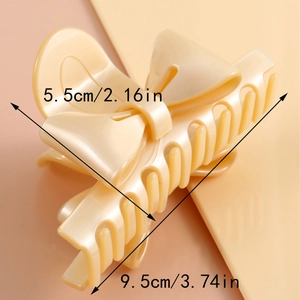French bow hair claw clip in cream finish with 9.5cm length dimensions shown