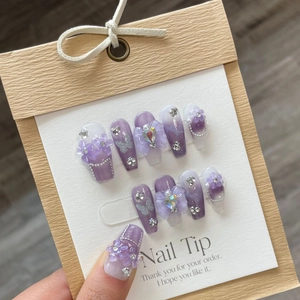 Handmade purple galaxy press-on nails with 3D floral and rhinestone nail art embellishments
