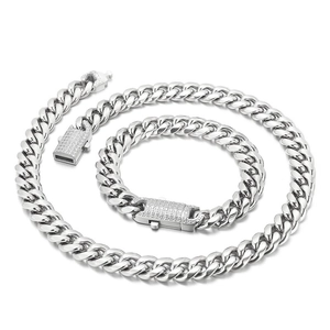 Detail of silver Cuban link necklace and bracelet set with diamond encrusted clasps