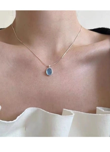 Detail of S925 silver necklace featuring a clear light blue oval gemstone pendant