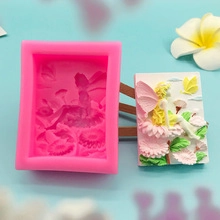 Close-up of pink silicone soap mold with detailed fairy and flower relief patterns