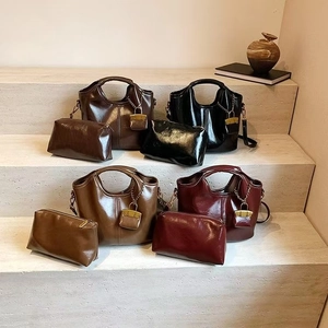 Detail view of vintage oil wax leather tote bags set in four retro colors and textures