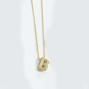 Close-up of golden cable chain necklace with micro-pave zircon letter B pendant