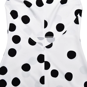 Detail of invisible zipper and fine stitching on white polka dot backless summer dress