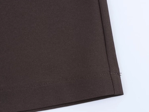 Close-up of premium dark brown fabric texture and precise stitching on the blazer set