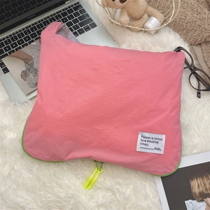 Close-up of pink waterproof travel organizer with green and yellow contrast zippers