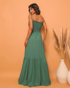 Detail of green maxi dress featuring smocked back and layered ruffle hemline