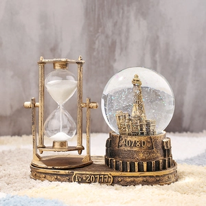 Close-up of vintage bronze hourglass and crystal ball globe desk ornament detail