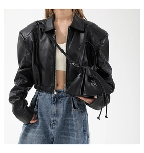 Detailed view of the dark punk triangle handbag with metallic studs and drawstring closure