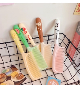 Detailed view of 5 colorful cartoon hair combs with cute animal and fruit 3D designs