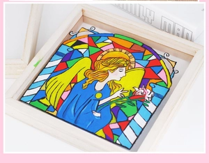 Detail of wooden picture frame featuring colorful stained glass art of an angel with roses