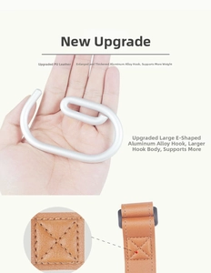 Macro view of brown leather strap with X-stitch reinforcement and large aluminum alloy hook