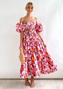 Detail of floral puff sleeve off-shoulder dress with layered ruffles and vibrant prints