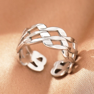 Detailed macro shot of silver braided chain links and hollow texture on a sleek open ring