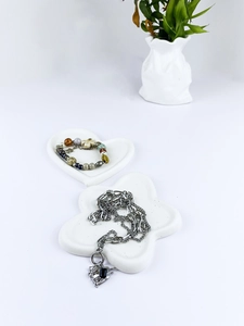 Minimalist white heart and flower jewelry trays with metal necklace and beaded bracelet