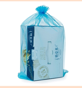 Close-up of a blue sheer organza drawstring jewelry pouch with a translucent mesh texture