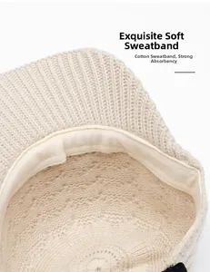 Detail shot of the beige knit baseball cap showing the soft, breathable inner sweatband