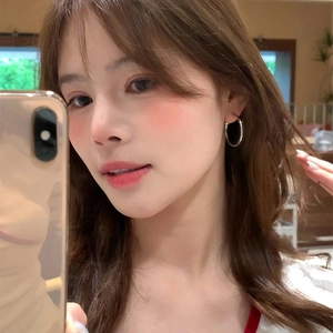 Silver round hoop earrings shown in a mirror selfie on ears for a minimalist daily look