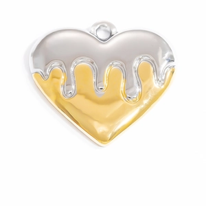 Macro shot of liquid heart pendant with high-shine silver and 18K gold two-tone metallic finish
