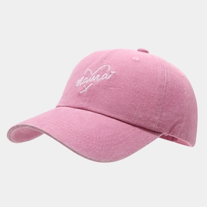 Close-up of pink washed cotton baseball cap with white Mama embroidery and heart detail