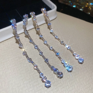 Macro detail of silver drop tassel earrings with sparkling cubic zirconia stones