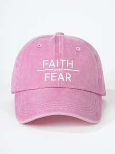 Close-up of FAITH over FEAR white embroidery on pink washed cotton baseball cap