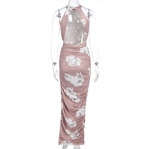 Detail of ruched side seams and large white floral print on a mauve halter maxi dress