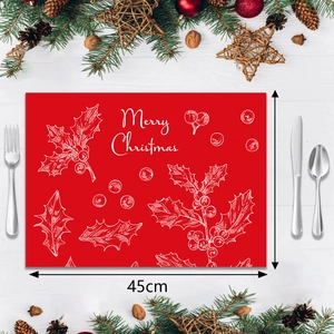 Close-up of 45cm red Christmas placemat with holly patterns and Merry Christmas text