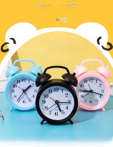 Three colorful quartz alarm clocks in blue, black, and pink with matte finishes