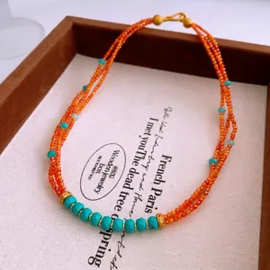 Vintage triple-strand beaded necklace with orange faceted beads and turquoise accents