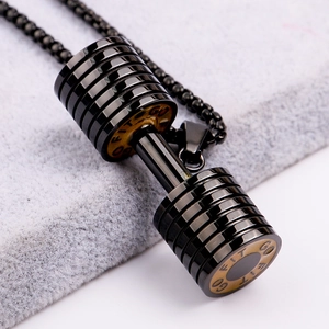 Macro shot of black stainless steel dumbbell pendant necklace with GO FIT engraving