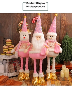 Detailed view of plush pink Christmas gnome dolls with sequin hats and gold boots