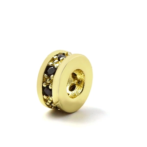 Macro shot of gold-plated copper spacer bead with micro-paved black zircon stones