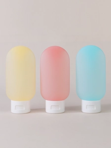 Three-piece set of 60ml travel squeeze bottles in yellow, pink, and blue silicone