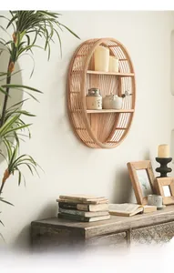 Detail view of oval bamboo wall shelf with three tiers in natural rustic home setting