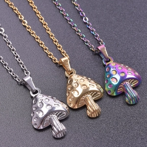 Macro shot of colorful mushroom pendants in silver, gold and rainbow stainless steel