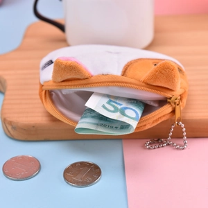 Cute orange and white plush cat coin purse with zipper and metal keychain on wooden tray